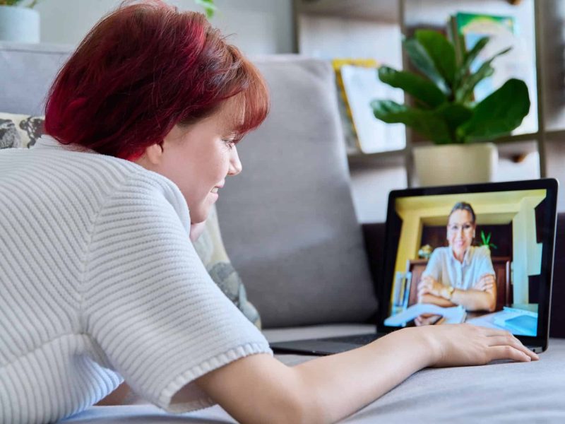 Online therapy session of teenage female with psychologist